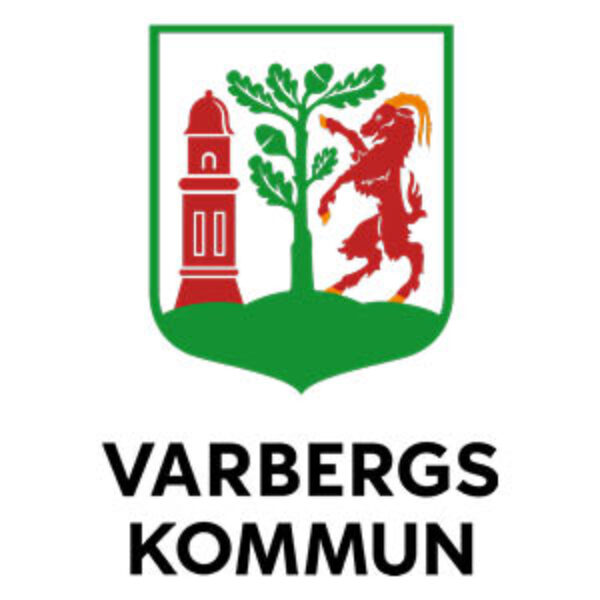 Varbergs Kommun coat of arms logo shows a green shield with a red tower on the left, a green tree in the center, and a red lion on the right above a green hill; text reads “VARBERGS KOMMUN”.